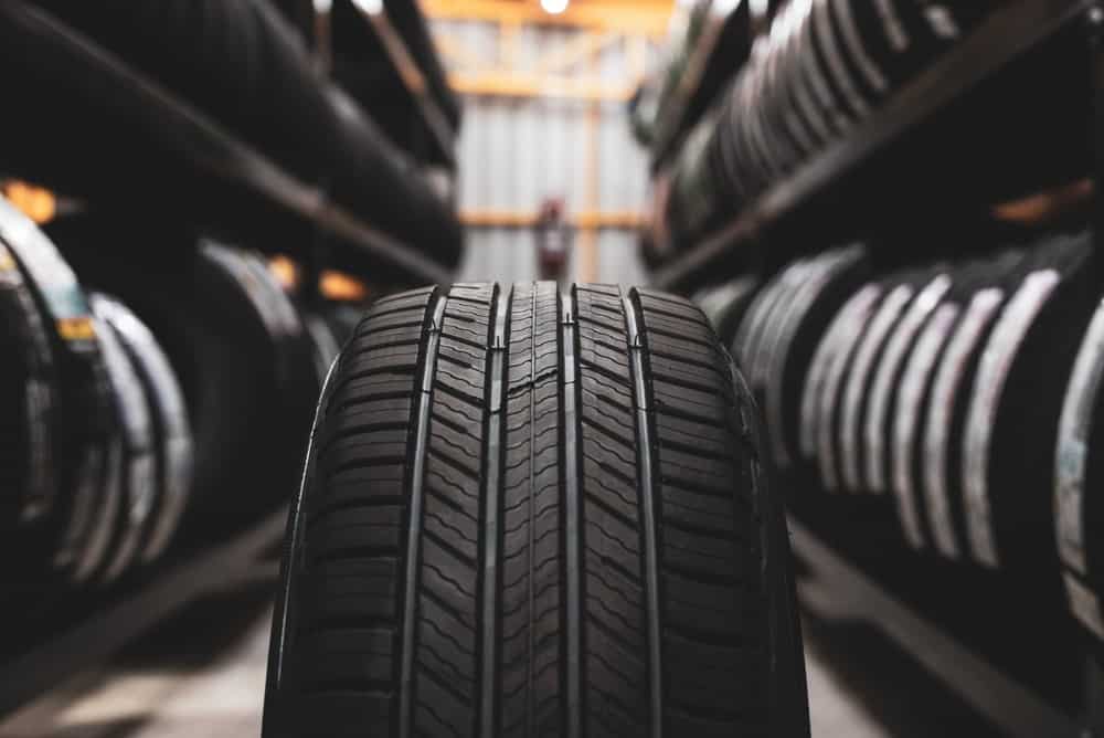 Best Tire Selection Guide | Iowa City Tire Experts | Auto Repair Shop. New tire placed on storage rack of tires at shop.
