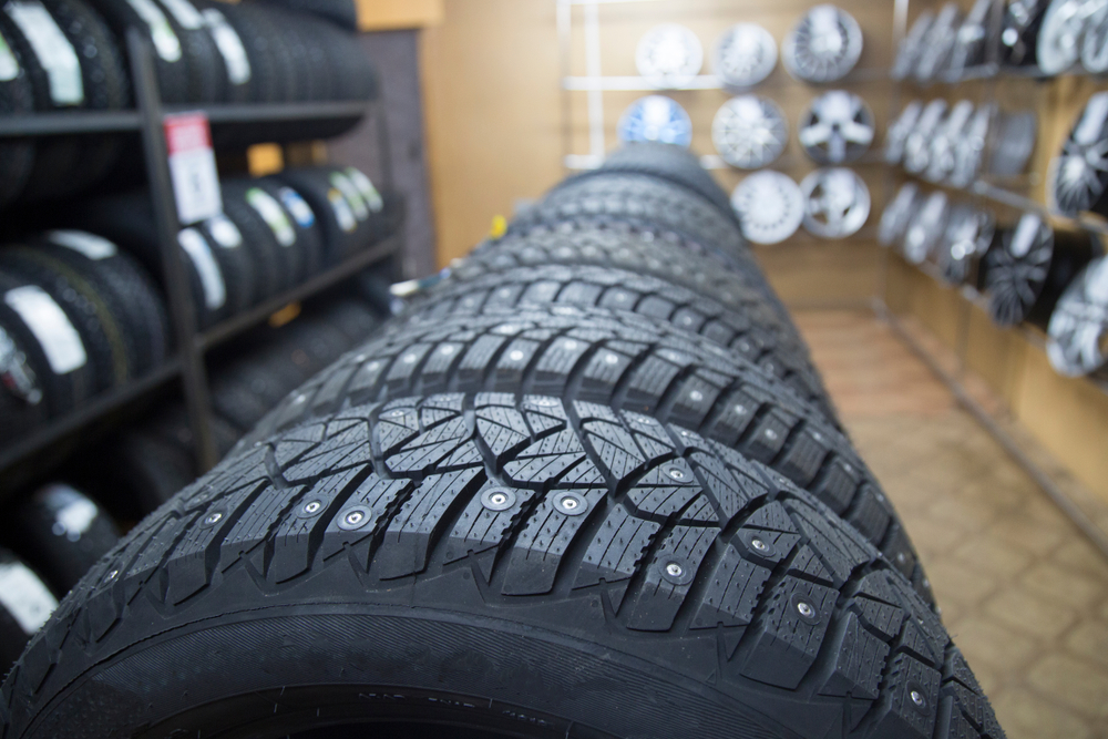 Top Tires in Iowa City, IA by Iowa City Tire and Service: A row of new tires displayed in a tire shop, showcasing the variety and quality available for vehicle owners to ensure safety and optimal performance.